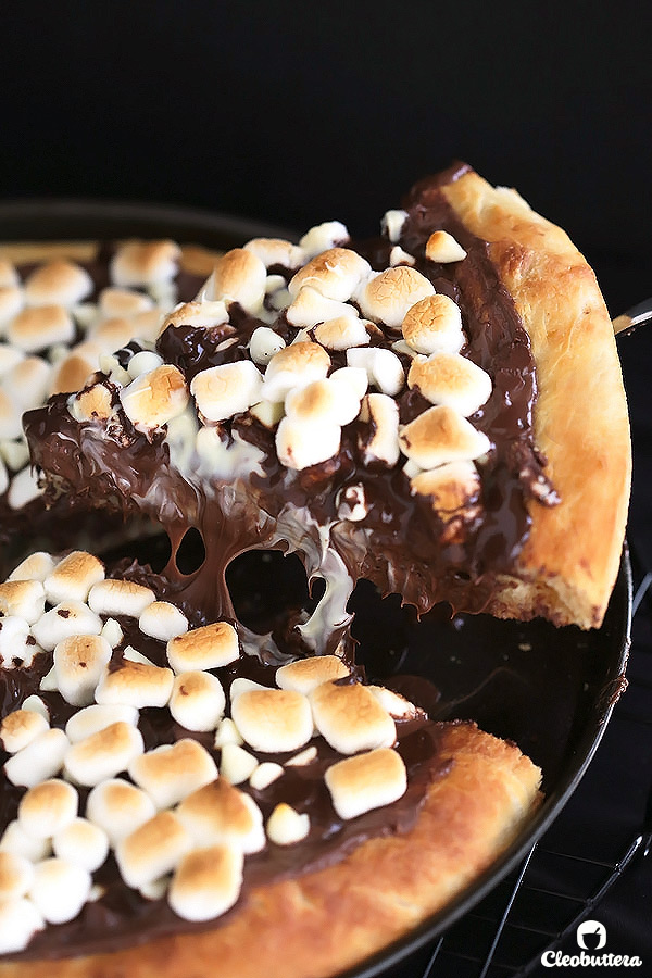 Soft pizza crust topped with Nutella, 3 types of chocolate and toasted marshmallows. This dessert pizza is a chocolate lover's dream come true.