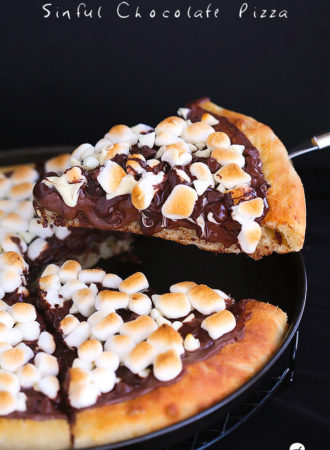 Sinful Chocolate Pizza...Soft pizza crust topped with Nutella, 3 types of chocolate and toasted marshmallows. This dessert pizza is a chocolate lover's dream come true.