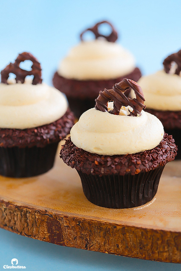 Peanut Butter Lava Fudge Cupcakes {Soft & tender chocolate cupcake filled with hot fudge sauce, frosted with a whipped, fluffy peanut butter frosting & topped with a chocolate covered pretzel}