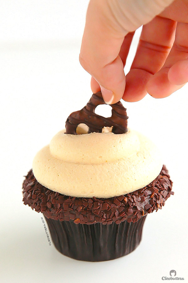 Peanut Butter Lava Fudge Cupcakes {Soft & tender chocolate cupcake filled with hot fudge sauce, frosted with a whipped, fluffy peanut butter frosting & topped with a chocolate covered pretzel}