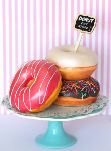 Donut Cake {3D sculpted, fondant covered, cake made to look like 3 different kinds of glazed donuts}.