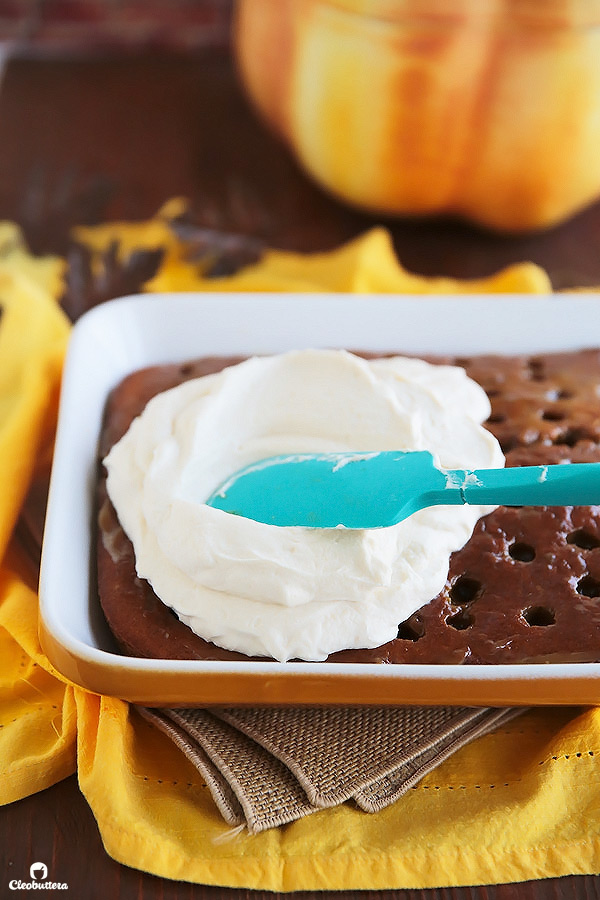 This superbly moist pumpkin spiced cake is so easy to make and always a big hit! Made from a revamped cake-mix, this cake oozes out with pockets of sweetened condensed milk, not-too-sweet caramel sauce, and smothered with clouds of caramel whipped cream and pecans. YUM!