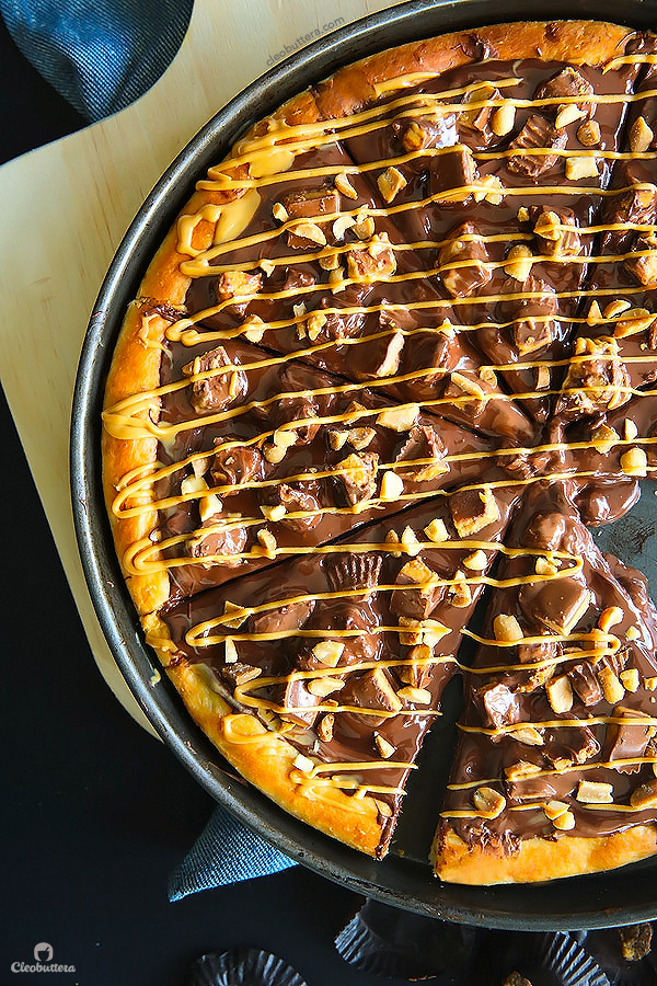 A dessert pizza on peanut butter steroids! Soft pizza crust, melted chocolate, chopped Reese's, salted peanuts and a peanut butter drizzle. YUM!