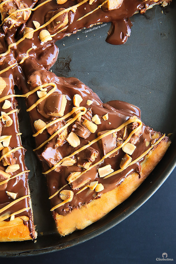 A dessert pizza on peanut butter steroids! Soft pizza crust, melted chocolate, chopped Reese's, salted peanuts and a peanut butter drizzle. YUM!