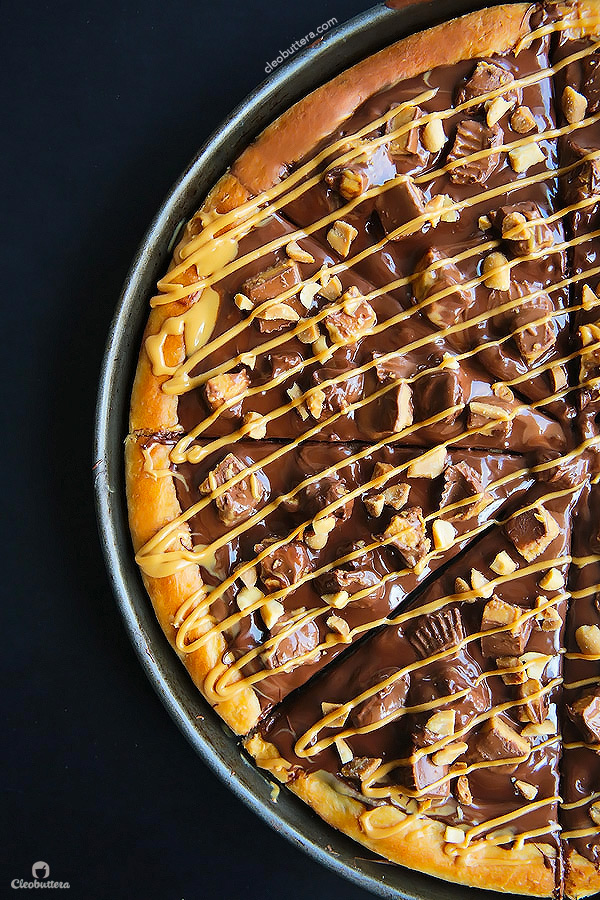 A dessert pizza on peanut butter steroids! Soft pizza crust, melted chocolate, chopped Reese's, salted peanuts and a peanut butter drizzle. YUM!