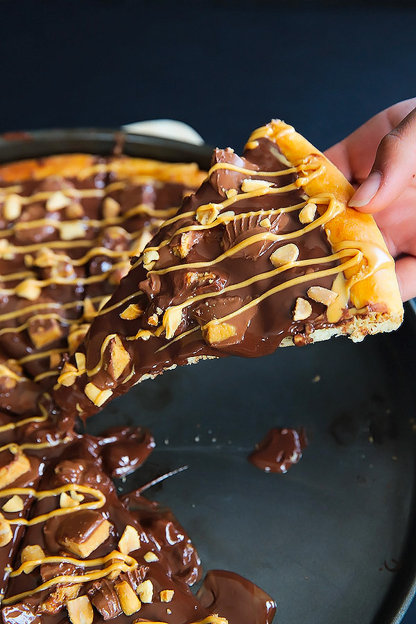 A dessert pizza on peanut butter steroids! Soft pizza crust, melted chocolate, chopped Reese's, salted peanuts and a peanut butter drizzle. YUM!