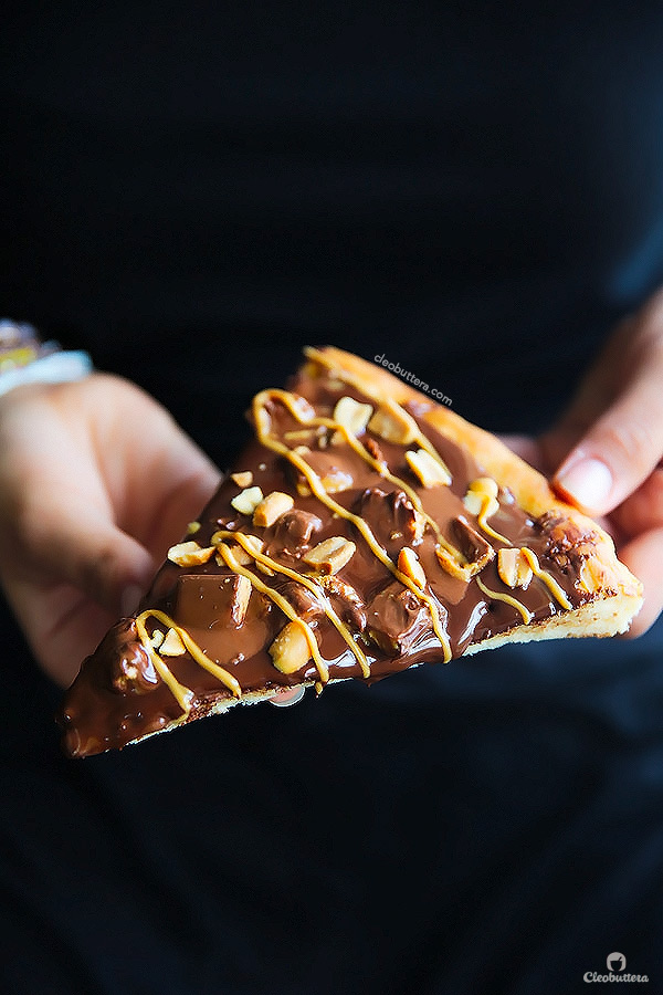 A dessert pizza on peanut butter steroids! Soft pizza crust, melted chocolate, chopped Reese's, salted peanuts and a peanut butter drizzle. YUM!