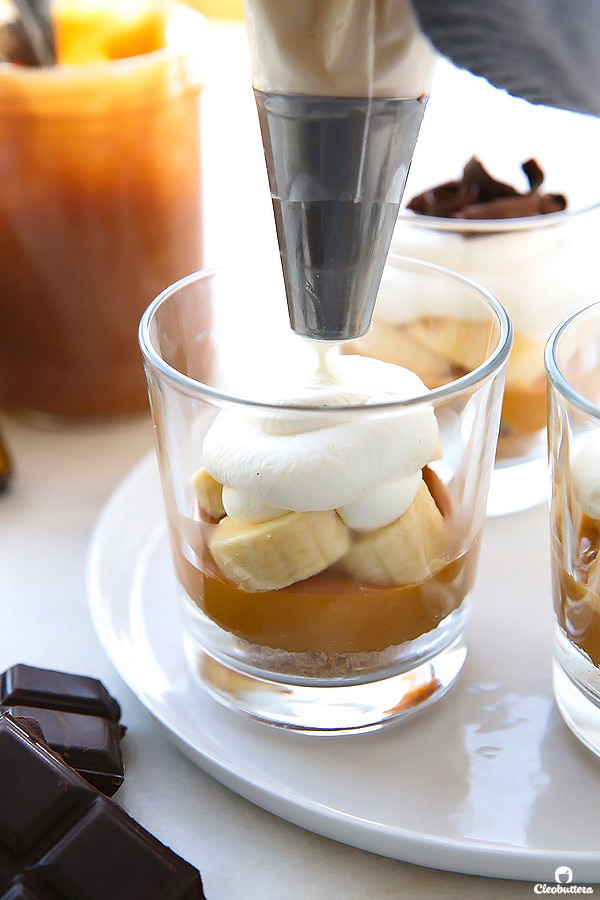 The much loved banana toffee pie made even simpler in cute little individual cups! With layers of digestive biscuit crust, dulce de leche, banana slices and whipped cream, this no-bake “pie” is dangerously delicious and a cinch to make!