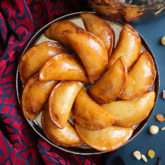 A Middle Eastern favorite, traditionally served during the month of Ramadan! Made from a type of yeasted pancakes stuffed with nuts, fried to crunchy, golden perfection, then doused in simple syrup.