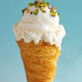 The classic cream konafa just got ice cream-ized! Crunchy, sweetened konafa cones served with a no-churn rose and orange blossom water scented eshta ice cream
