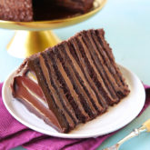 Twelve layers of chocolate cake filled with alternating layers of silky chocolate pastry cream and rich fudgy chocolate frosting.   This 6-inch tall mega cake might just be the best chocolate cake you'll ever taste.