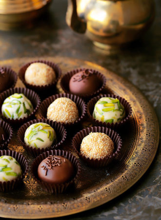 The coolest new way to enjoy halawa! Easy, homemade Halawa (Tahini Halva) made from scratch and revamped into the most elegant little truffles.  Roll them in either pistachios, sesame seeds or dunk them in glorious chocolate.  Plus...recipe VIDEO included!