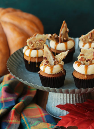 Soft pumpkin cupcakes infused with nutty brown butter, filled with cinnamon toffee sauce, topped with brown butter cream cheese frosting and shards of pumpkin spice toffee.