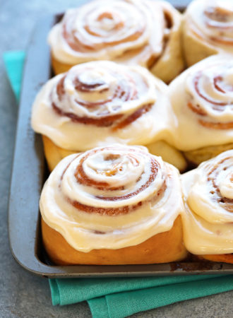 An amazing recipe for squishy soft cinnamon rolls with a super fluffy and tender texture and a gooey filling that caramelizes in the bottom.  A halo of perfectly sweet cream cheese frosting ties everything together.   A brilliant Asian technique called Tangzhong, ensures moist, airy rolls that stay soft for days.
