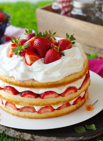 Three layers of soft and plush vanilla cake, infused with flavorful strawberry juice, topped with heaps of glazed fresh strawberries and swoops of thickened whipped cream that won't weep on you.