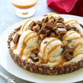 This easy ice cream pie is bursting with KitKat in every bite! Vanilla ice cream with crispy chunks of KitKat and swirls of salted caramel, sit atop a pie crust made from crushed KitKat bars.  Delicious!