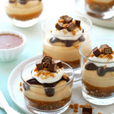  These delightful cups of decadence, feature a bottom base of crushed KitKat and roasted peanuts, salted caramel sauce, a cloud-like peanut butter filling, all topped off with a chocolate ganache sauce, whipped cream and chunks of KitKat and peanut bits.  VIDEO recipe at the end of the post!